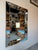 Stunning large-scale 1960’s Hollywood Regency style wall mirror featuring elegant beveled glass panels and a bold,...