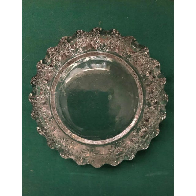 Classic 1950’s Crystal ashtray or Catchall with ribboned rim and under cut adding character while keeping a smooth basin....