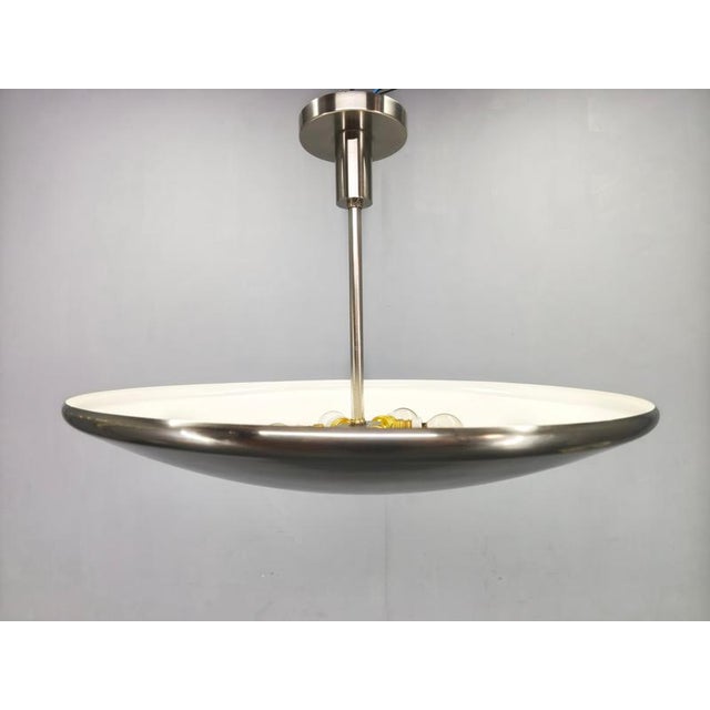 Authentic Bauhaus ceiling light from the 1930s, crafted in Czechoslovakia. This elegant pendant features a wide, dish-...