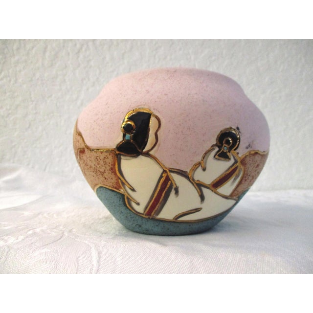 Vintage Southwestern ceramic bowl in shades of light beige, tan and aqua with glazed gold accents. Face of bowl features...