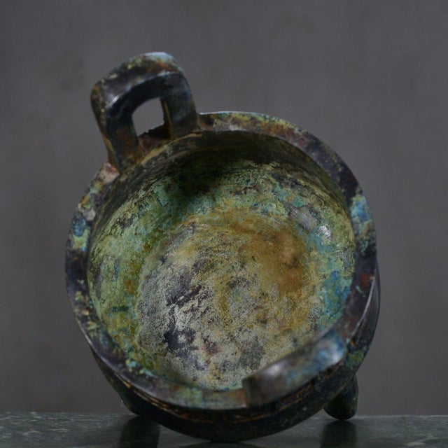 This striking tripod bronze Ding vessel is inspired by ancient Chinese ritual bronzes, symbolizing authority, stability,...