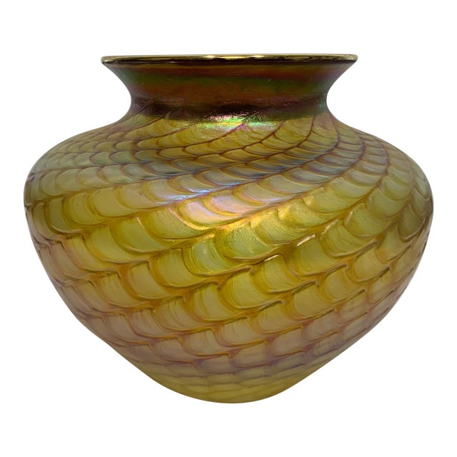 Modern art glass hand-blown vase in iridescent golds and several alluring colors from amber, yellow and muddled in patches...