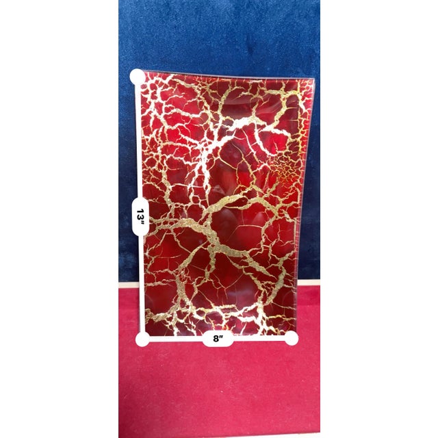 Mid-century modern style art glass tray featuring a rich crimson red base accentuated with intricate gold leaf veining in...