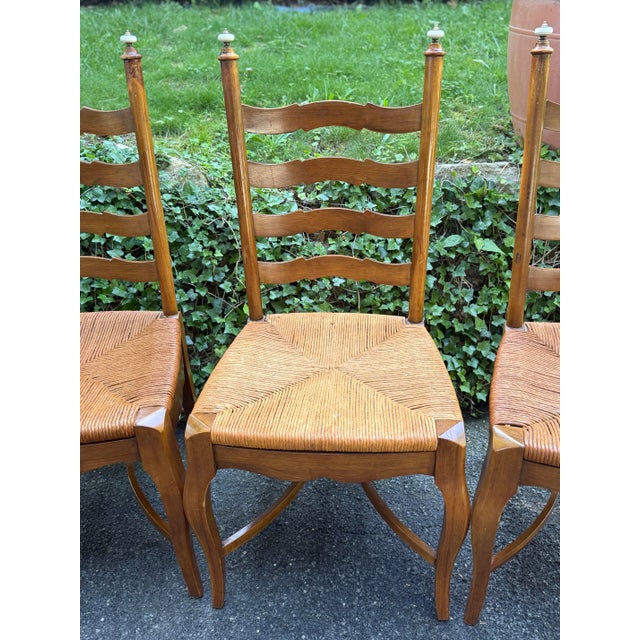 Charming set of solid walnut dining chairs. Features Ladderback design, cabriole legs supported with canted stretcher,...