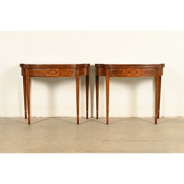A gorgeous pair of Federal or Hepplewhite style flip-top consoles or game tables By Baker Furniture USA, Circa 1980s...