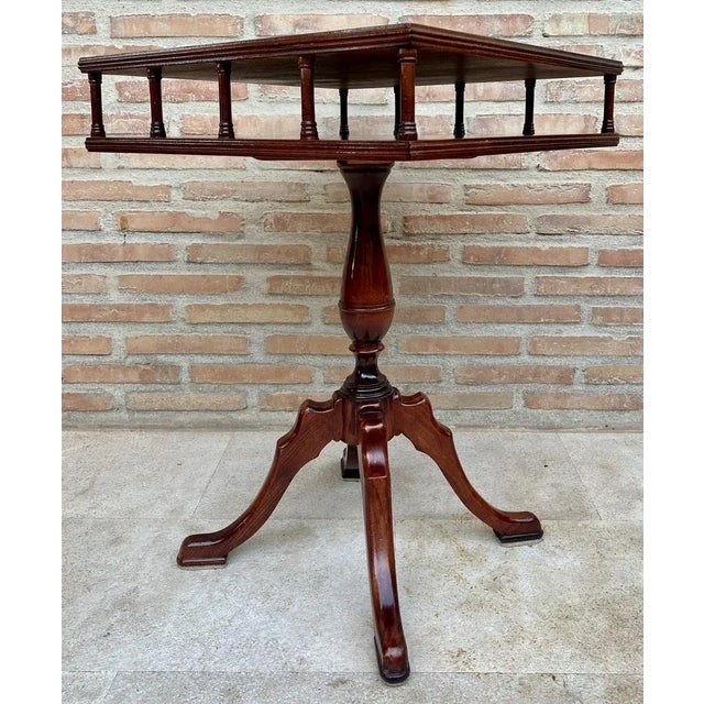 19th century Regency wooden side table with green leather upholstered top, having an open drawer or shelf, surrounded by...