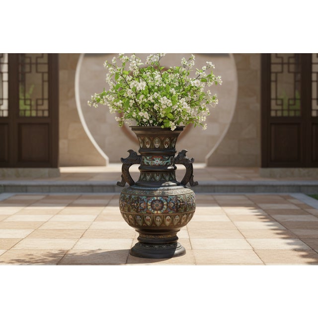 This monumental vase is a tour-de-force of the Jingtai Blue (cloisonné) technique. Standing nearly three feet tall, it...