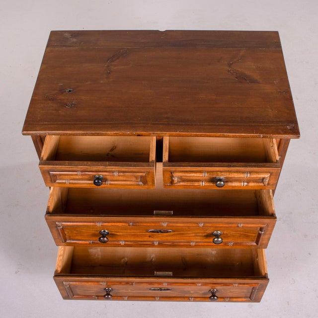 This handsome English chest of drawers brings together the honest warmth of pine with the exotic charm of the faux bamboo...