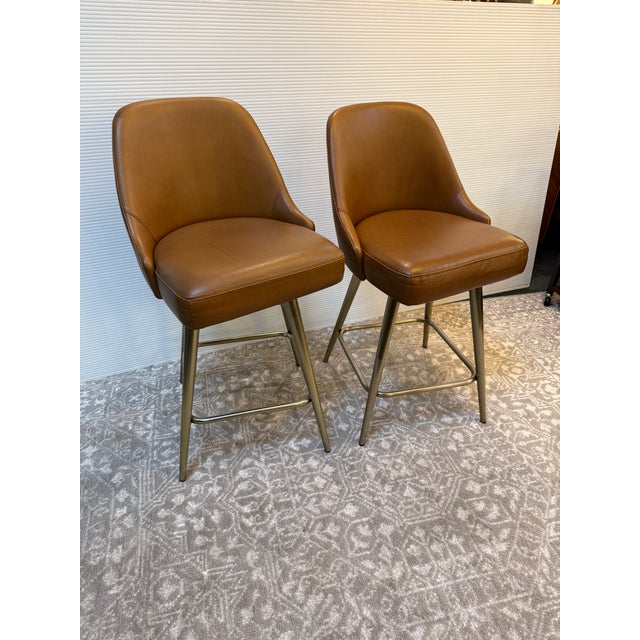 Design Plus Gallery presents a Pair of Mid Century Swivel Stools from West Elm. Presents timeless mid-century design to...