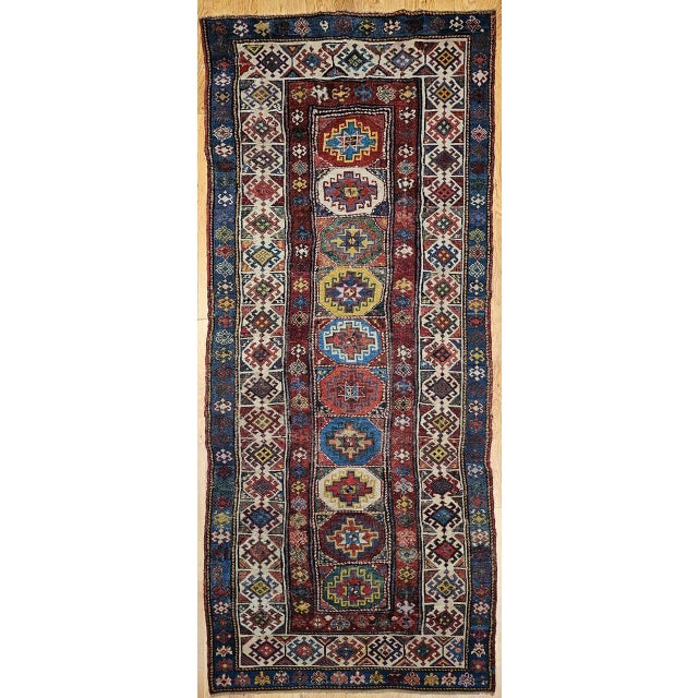 An exceptional 19th century Caucasian Kazak area rug, handwoven in the fourth quarter of the 1800s, showcasing the bold...