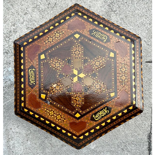 Add a touch of exotic charm to your living space with this unique vintage drinks table, showcasing intricate boho inlay...