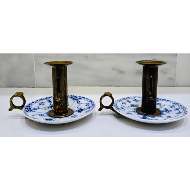 A handsome matched pair of vintage Royal Copenhagen push-up candleholders, also known as chambersticks, combining blue-...