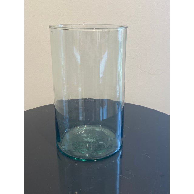 This elegant glass vase features a minimalist cylindrical design that seamlessly blends modern sophistication with...