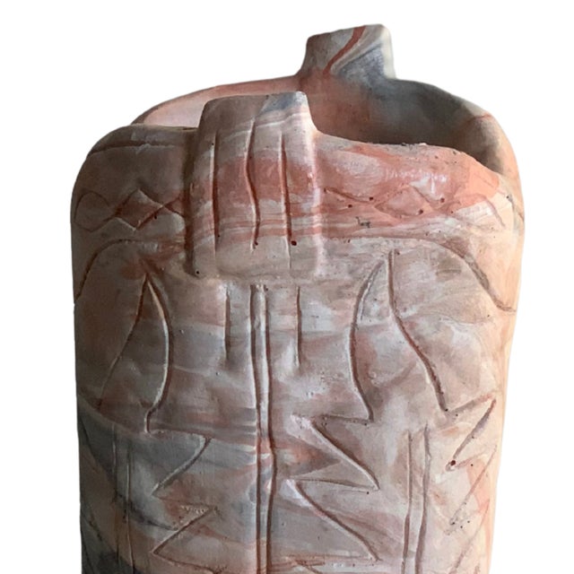 Vintage Western-style cowboy boot sculpture crafted in marbled clay with natural swirled tones of terracotta, gray, and...