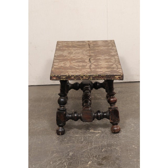 A Spanish coffee table with a 17th century hand-tooled and painted leather top on 18th century wooden base. This fabulous...