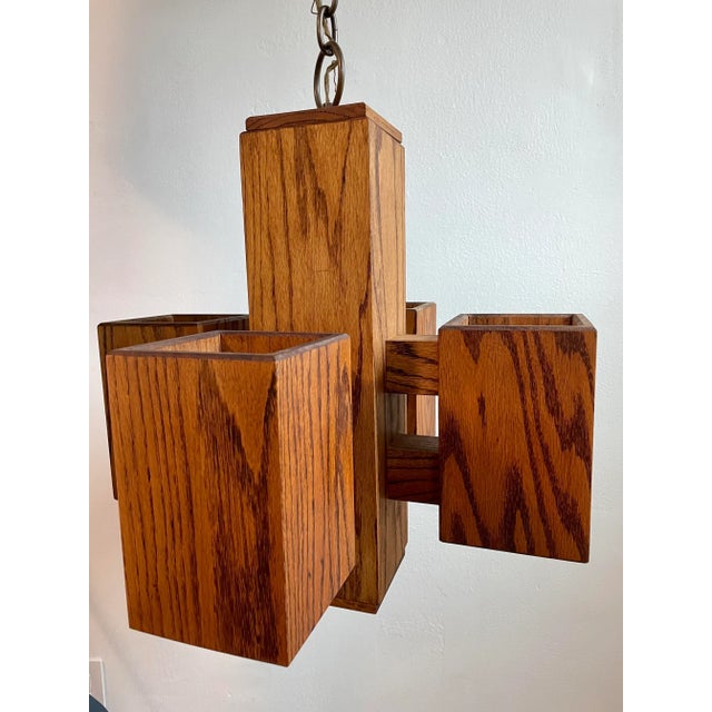 A vintage modernist style swag chandelier light fixture featuring architectural geometric box-form construction. The lamp...