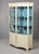 This English display cabinet follows the Hepplewhite tradition in two parts, both featuring a bow-fronted form. The upper...