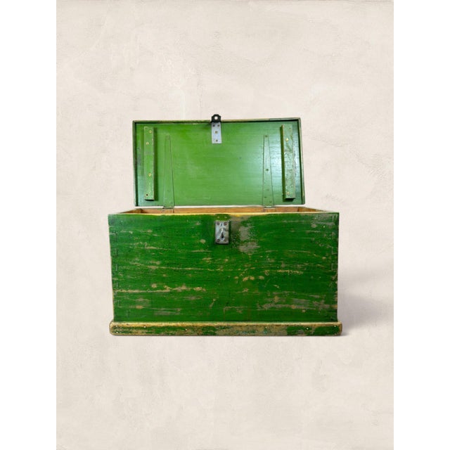 A character-rich antique English pine blanket chest dating to circa 1905, featuring a wonderfully timeworn green painted...