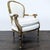 This elegant lounge chair features a comfortable white upholstered cushion and backrest. The frame is made of wood with...
