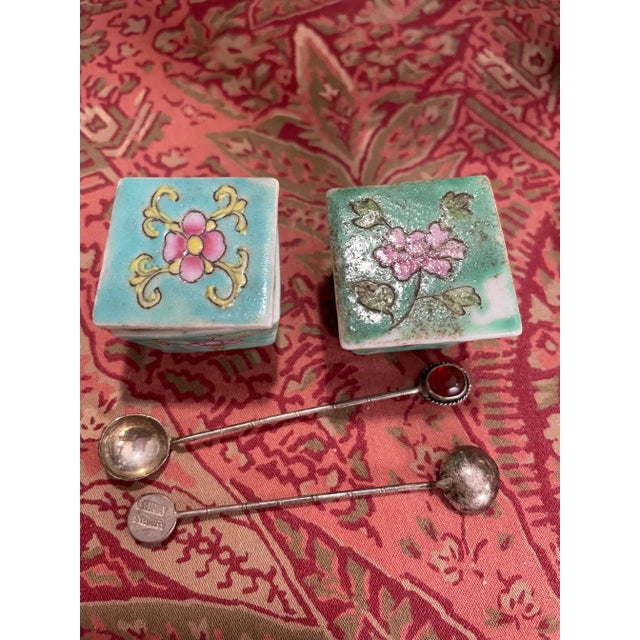 A set of (8) Chinese famille rose turquoise ground covered salt cellars 1"h x 1.5" square and (8) "China Silver" spoons...