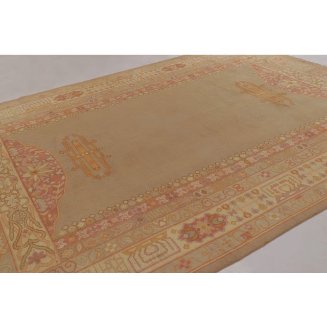 Made with hand-knotted circa 1910–1920, this 9x13 antique Indian rug is a rare and distinguished acquisition from the new...