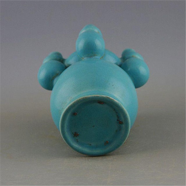 A distinctive Chinese ceramic vase finished in soft sky turquoise celadon glaze with subtle craquelure texture. This...