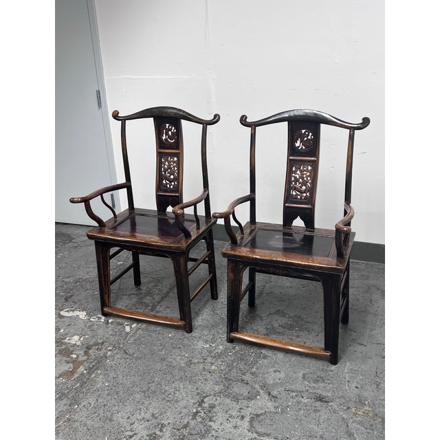 Design Plus Gallery presents a Pair of Antique Chinese Elmwood Armchairs from the Qing Dynasty, Circa 1750. These chairs...