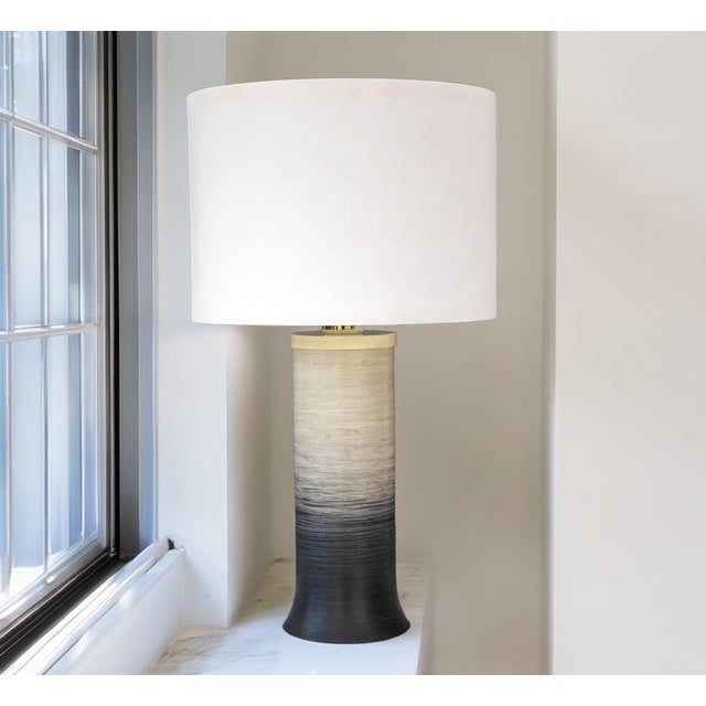 A large monochrome acrylic table lamp from 1980s, tranås stilarmatur sweden. The lamp fades from a very dark grey base to...