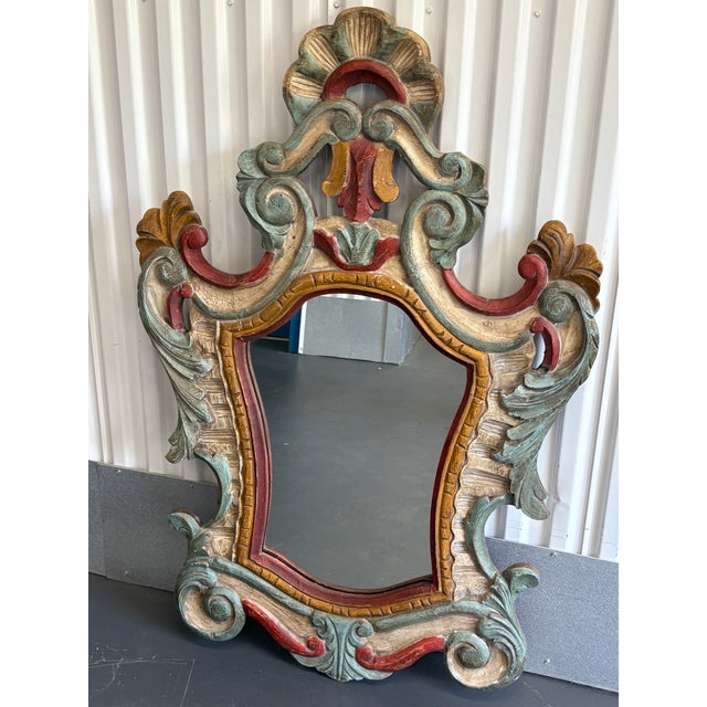 Hand carved mirror with beautiful colors of blue, red, white and gold. The mirror is hand carved, you can see the backside...