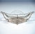 A whimsical jardinière in delicate silverwork with a diamond-shaped base, standing on four lion’s paws, a mounting in the...