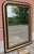 An elegant French-made mirror dating back to the late 19th century. The frame features a refined combination of gold leaf...