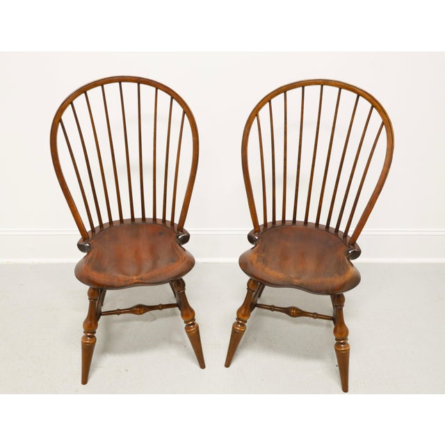 A pair of custom crafted bowback Windsor dining side chairs by D.R. Dimes. Solid maple turnings, oak bendings, and pine...