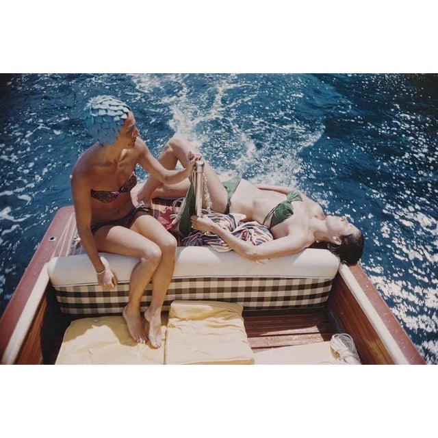 Vuccino and Rava 1958 Carla Vuccino, wearing a swimming cap, and a sunbathing Marina Rava, both wearing bikinis as they...