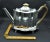 This marvelous antique George III style teapot and matching trivet are created in gorgeous sterling silver, produced by...