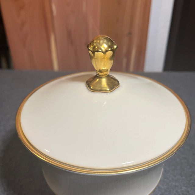 Cream colored lidded jar outlined in gold. Clean line neutral decor that can fit in most anywhere. Made in USA.