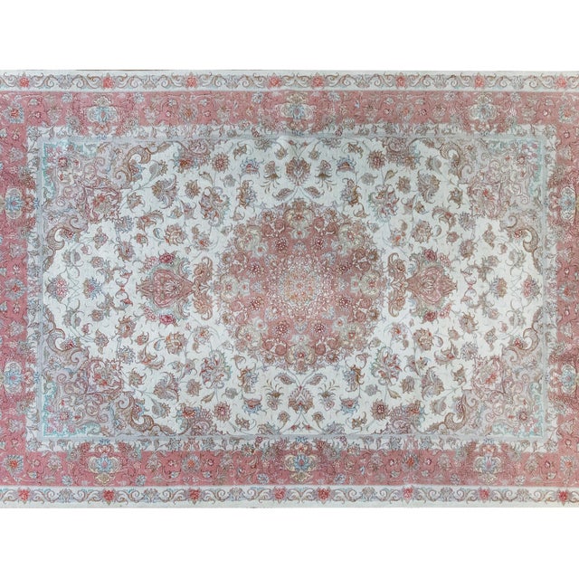 This vintage late 20th-century Persian Tabriz rug features a mesmerizing central floral medallion, woven with intricate...