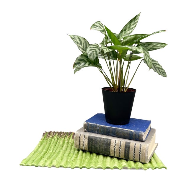 Bring a touch of garden-inspired charm to your home with this vintage ceramic platter modeled after a bundle of fresh...