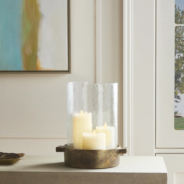 Made of hammered glass and cast aluminum, this hurricane has a classic look. The simple handles add a graphic element and...
