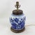 This antique table lamp is crafted from a classic white porcelain vase featuring a bold cobalt blue floral design. The...