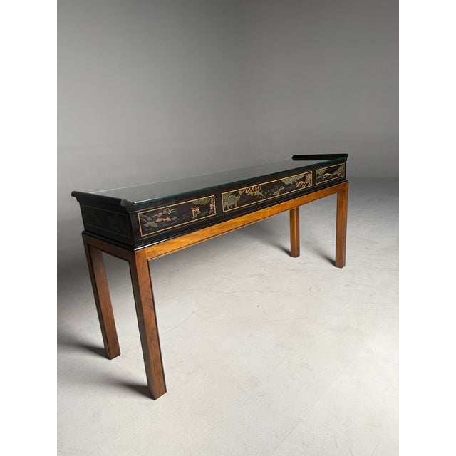 Late 20th century Drexel console with solid wood base, black lacquer finish, and fitted glass top. Elegant chinoiserie...