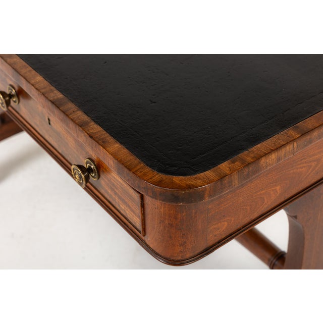 A super, good quality English Regency mahogany library table with aged green leather top. There are two drawers with brass...