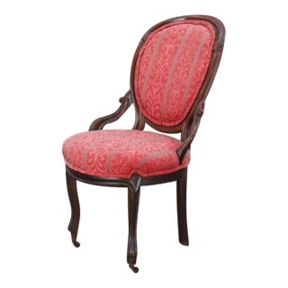 Antique Victorian Side Chair With Exposed Carved Mahogany Frame on Front Caster Feet and Cushioned Patterned Red Upholstery For Sale