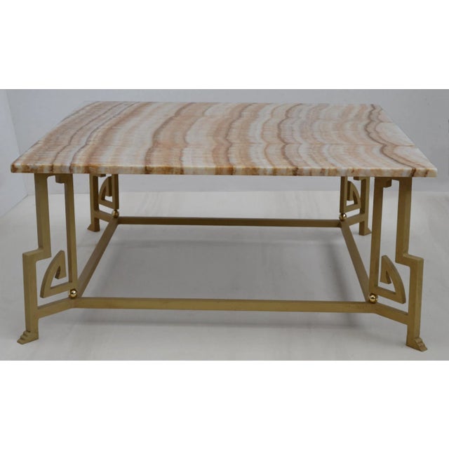 Coffee table with Arco Iris onyx top and wrought iron base. This coffee table will make a valuable addition to your decor....