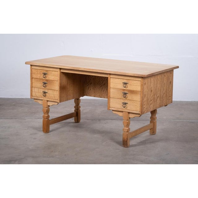 Oak desk attributed to Danish designer Henning Kjærnulf, crafted in Denmark during the 1960s. Designed in a distinctive...