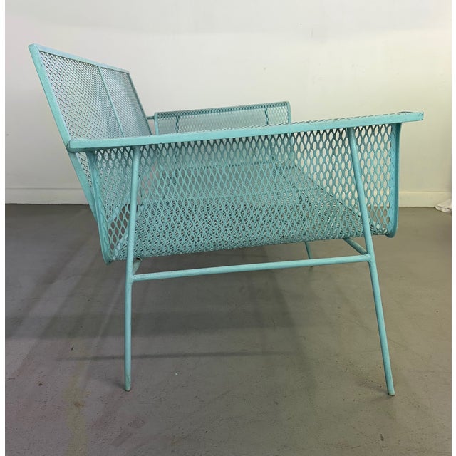 A striking mid-century modern metal mesh settee featuring a sculptural silhouette and airy architectural form. Constructed...
