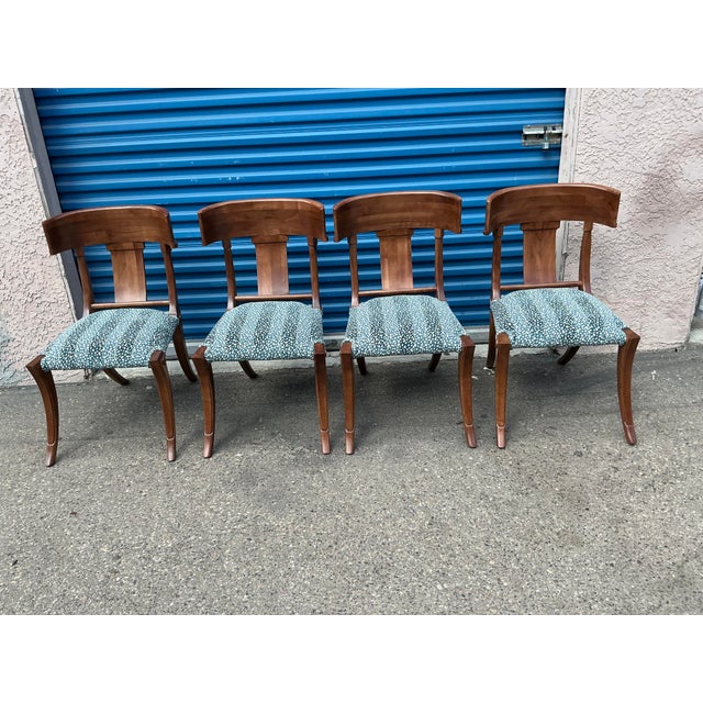Klismos style dining chairs. The chairs are made of solid walnut with a walnut finish and upholstered in a blue chenille ....