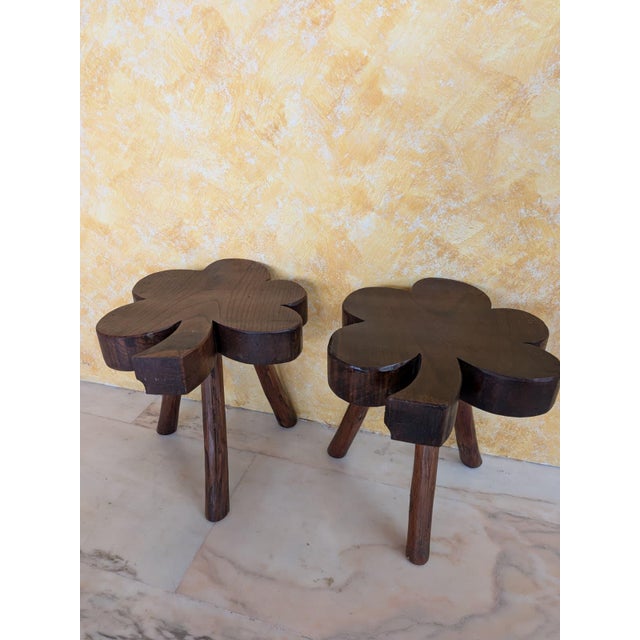 Pair of vintage tripod stools in the shape of a clover. Handcrafted from solid wood with a beautiful dark walnut finish....