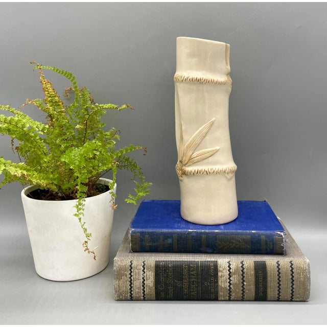 Charming, Hollywood regency ceramic vase in the shape of a bamboo stalk. Features a lovely and versatile off-white cream...