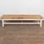 Rustic 20th-century pine farmhouse coffee table with original white painted base displaying natural paint wear and loss....