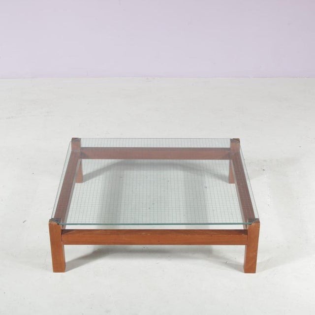 A beautiful low square coffee table, manufactured in the Netherlands in the 1960s. Made of nice, warm brown wood in a...